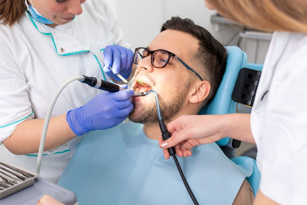 A man is seated in a dental for treatment